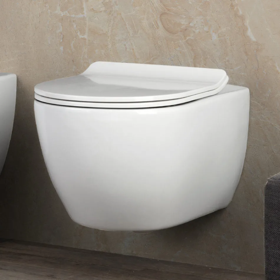 Vaso sanitário suspenso Aster em cerâmica branca, sem aro, com assento de fechamento suave. Viadurini